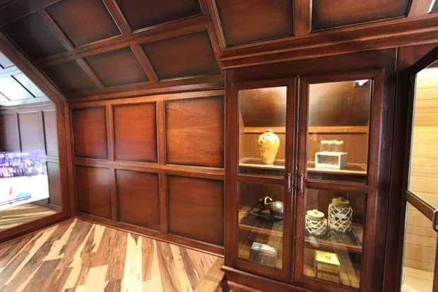 A glass-front display cabinet set into raised wood paneling.