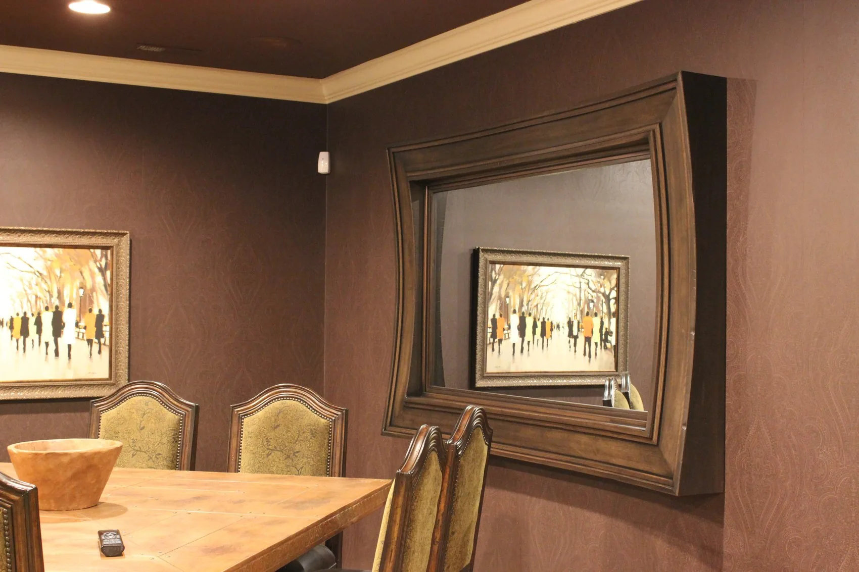 A deep Lyptus hardwood frame around a mirror on a dining room wall.